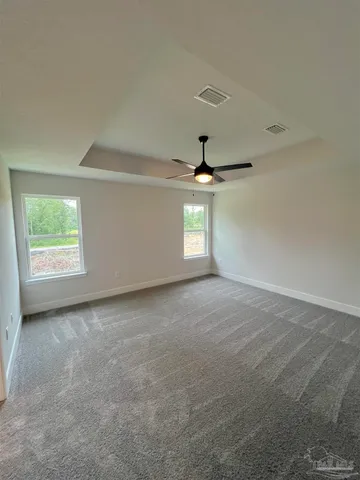 an empty room with a empty space and a ceiling fan