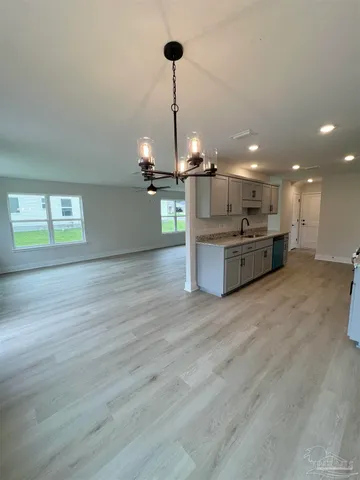 a view of a kitchen with a sink and a stove top oven