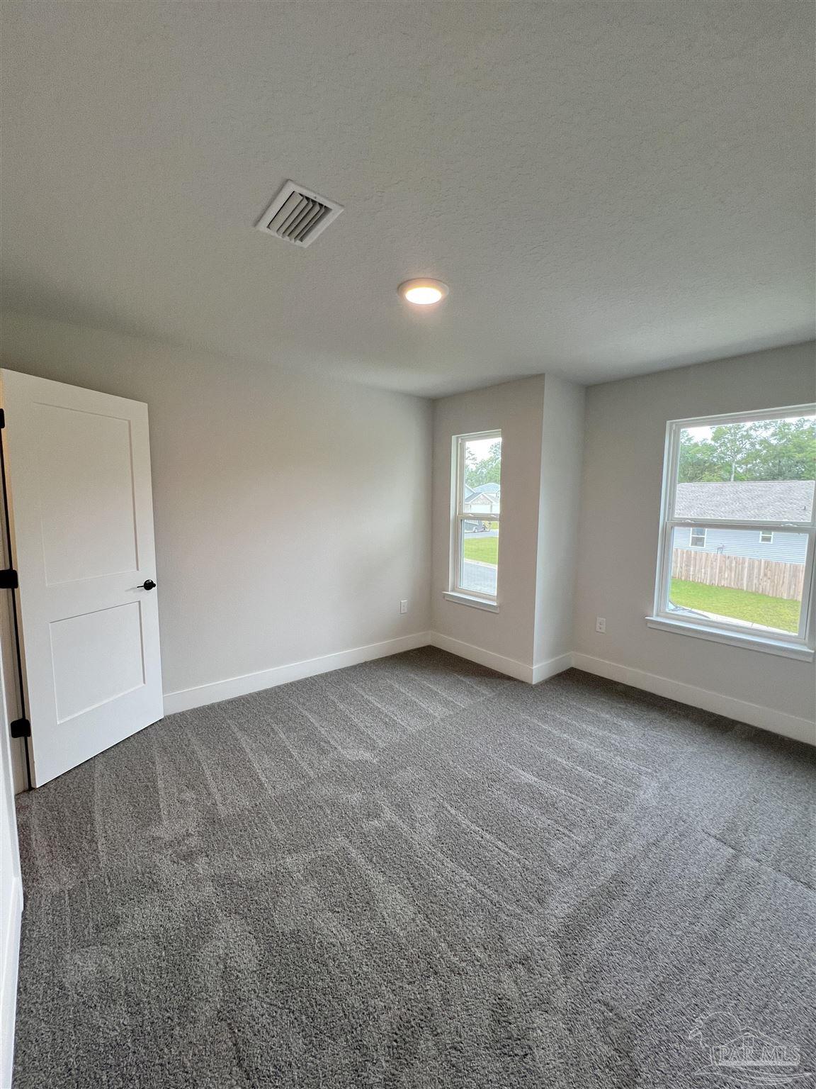 944 Rustling Pnes Road, Unit 12B Cantonment, FL 32533 - Photo 8 of 16 an empty room with windows