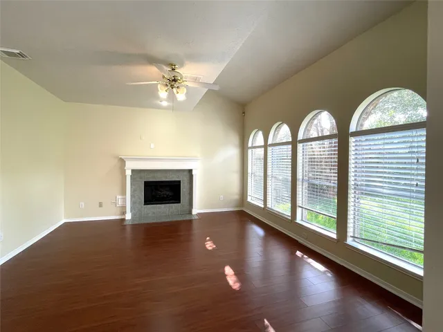 wooden floor in an empty room with a fireplace