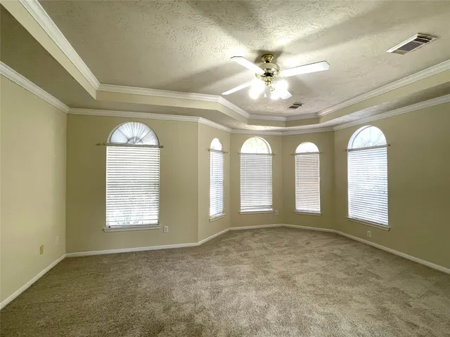 an empty room with windows and chandelier