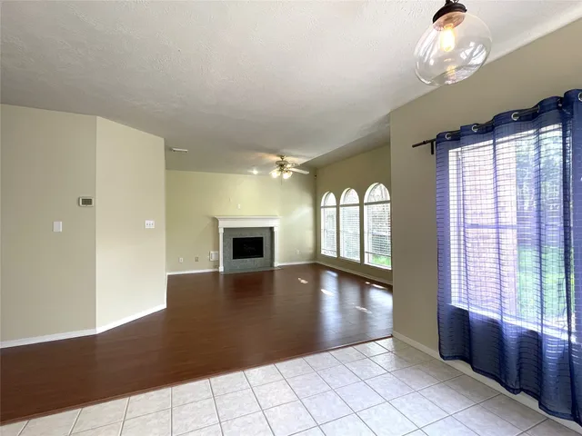 a view of an empty room with window and cabinet