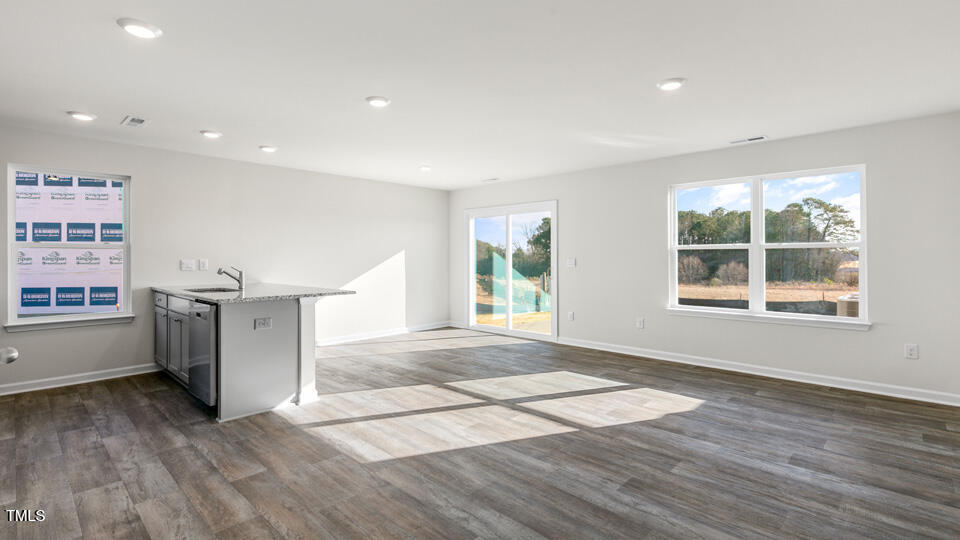 32 Red Clover Drive Angier, NC 27501 - Photo 14 of 38 a view of an empty room with wooden floor and a window