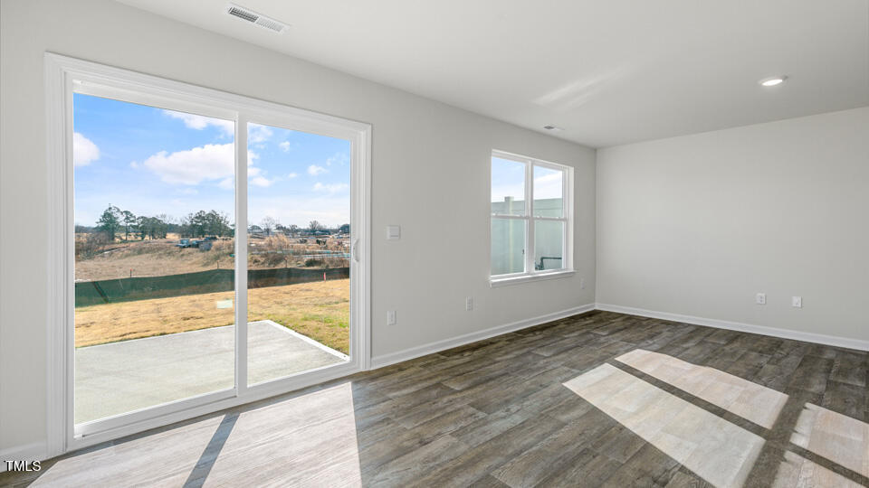 32 Red Clover Drive Angier, NC 27501 - Photo 15 of 38 a view of an empty room with wooden floor and a window
