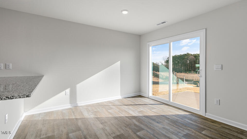 32 Red Clover Drive Angier, NC 27501 - Photo 16 of 38 a view of an empty room with wooden floor and a window