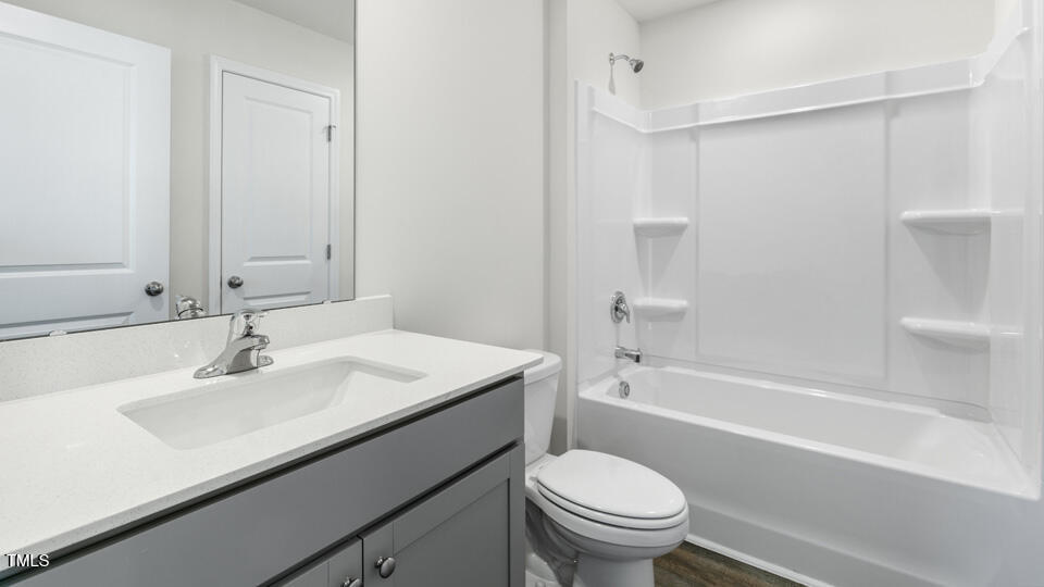 32 Red Clover Drive Angier, NC 27501 - Photo 28 of 38 a bathroom with a sink a toilet and a bathtub