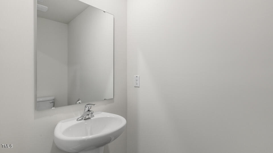 32 Red Clover Drive Angier, NC 27501 - Photo 29 of 38 a bathroom with a sink and a mirror