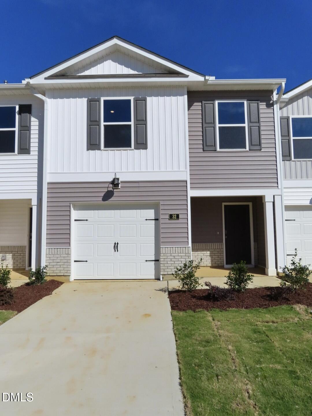 32 Red Clover Drive Angier, NC 27501 - Photo 4 of 38 a front view of a house with a yard and garage