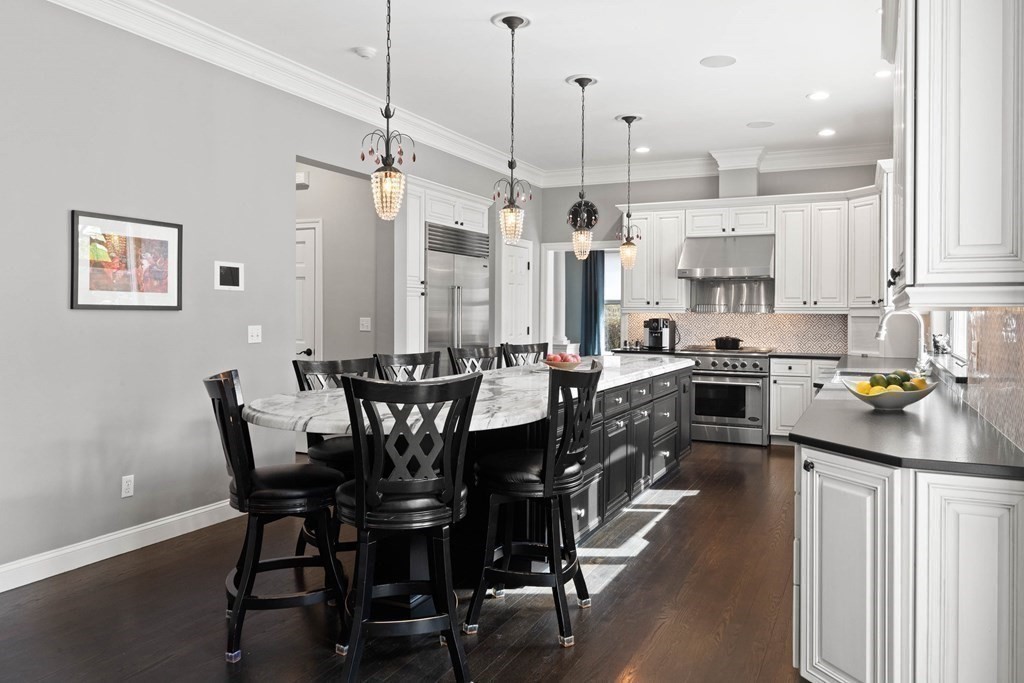 19 A Bayns Hill Road Boxford, MA 01921 - Photo 9 of 41 a kitchen with stainless steel appliances a table a sink and cabinets