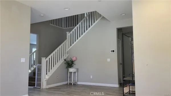 a view of entryway and hall with wooden floor
