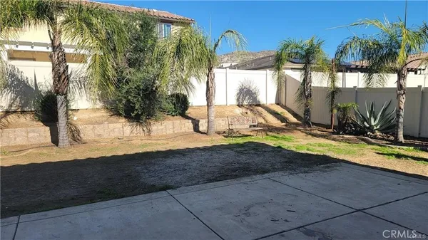 a view of a backyard patio and swimming pool