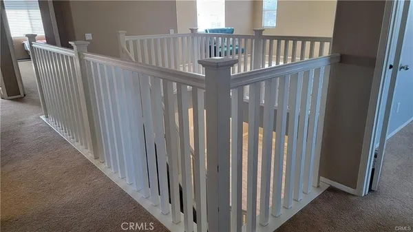 a view of staircase with railing and stairs