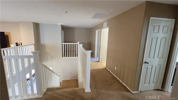 a view of a hallway with entryway door