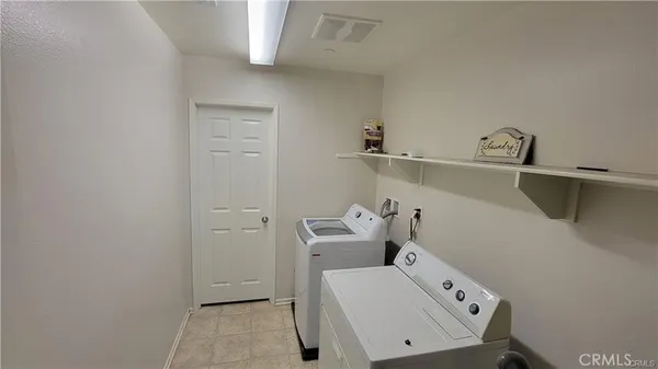 a view of a patio with table and chairs and potted plants