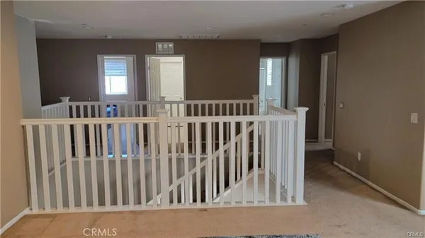 a kitchen with stainless steel appliances granite countertop a kitchen island a table and chairs in it