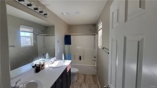 a kitchen with granite countertop a sink stove and refrigerator