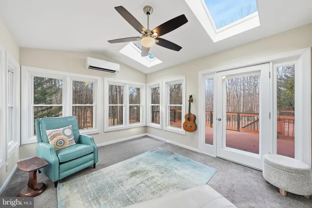 a living room with furniture and a large window with outer view