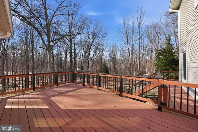 a balcony with wooden floor and trees