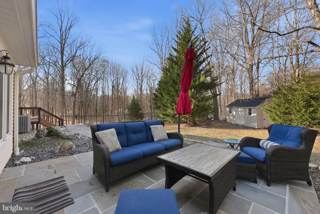 a outdoor space with patio couches and a dining table with garden view