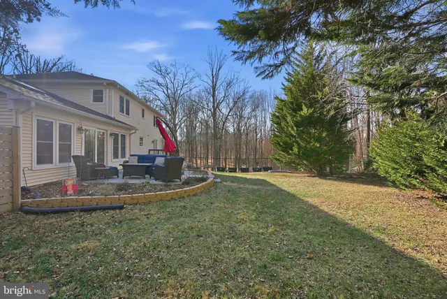 a view of backyard of house with green space