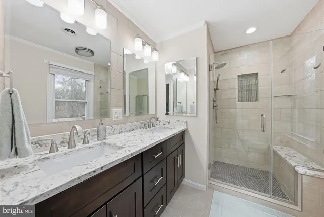 a bathroom with a granite countertop sink mirror and double