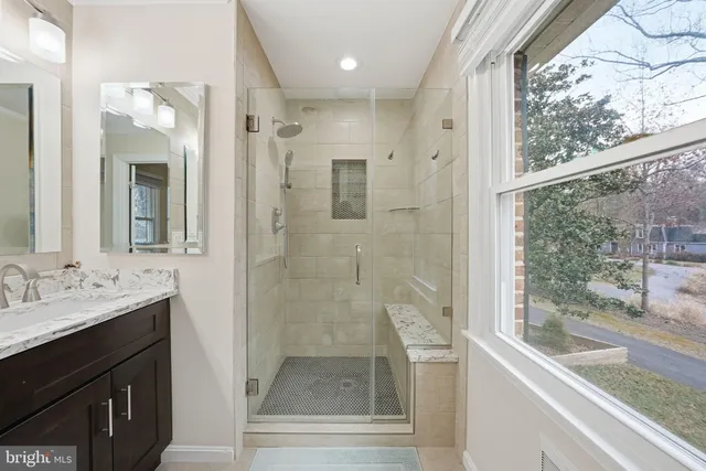 a bathroom with a shower sink and mirror