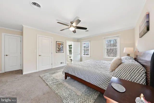 a bedroom with a bed and dresser with mirror