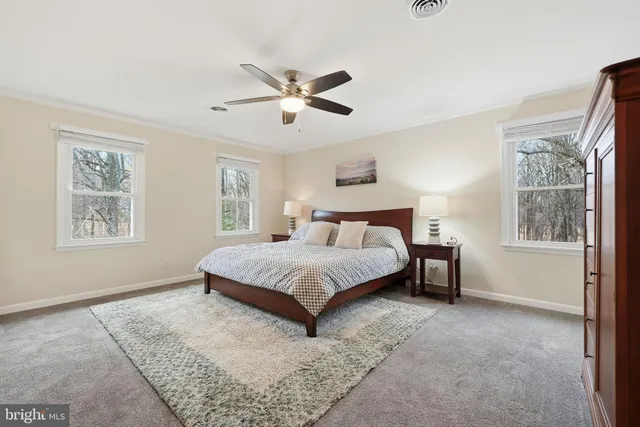 a spacious bedroom with a bed and a window