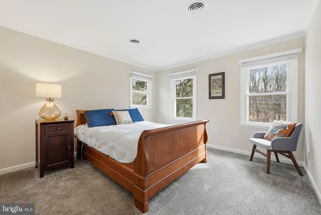 a bed room with a bed and a chair