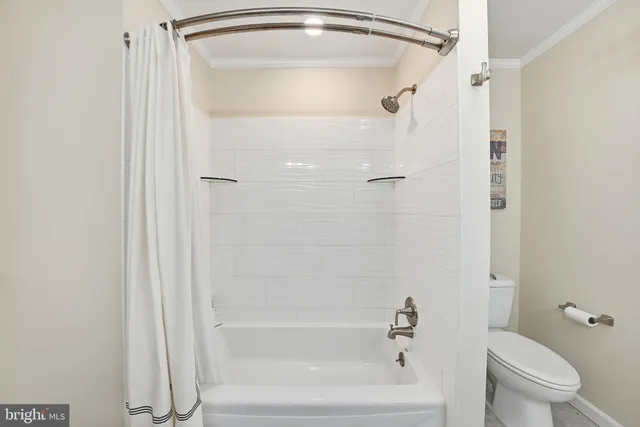 a bathroom with a shower a toilet and a sink