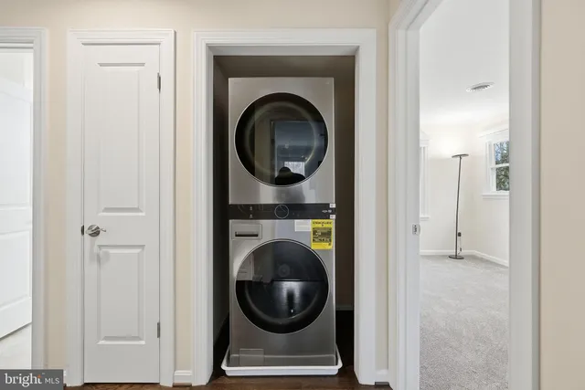 a view of a hallway with washer and dryer