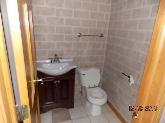 2401 East 29th Road Seneca, IL 61360 - Photo 14 of 26 a bathroom with a sink a toilet and shower