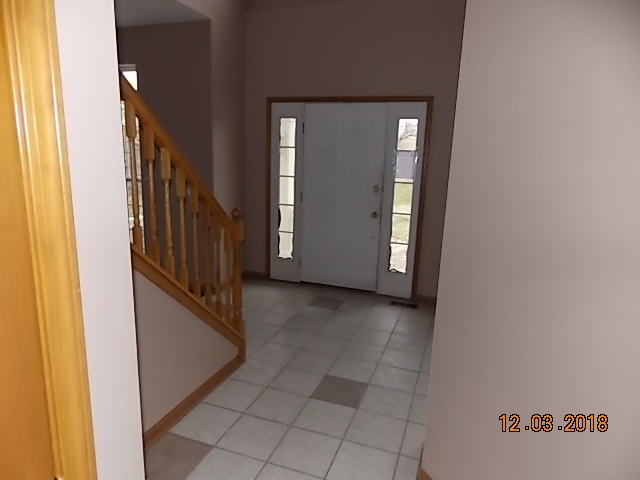 2401 East 29th Road Seneca, IL 61360 - Photo 8 of 26 a view of a hallway with wooden cabinets and stairs