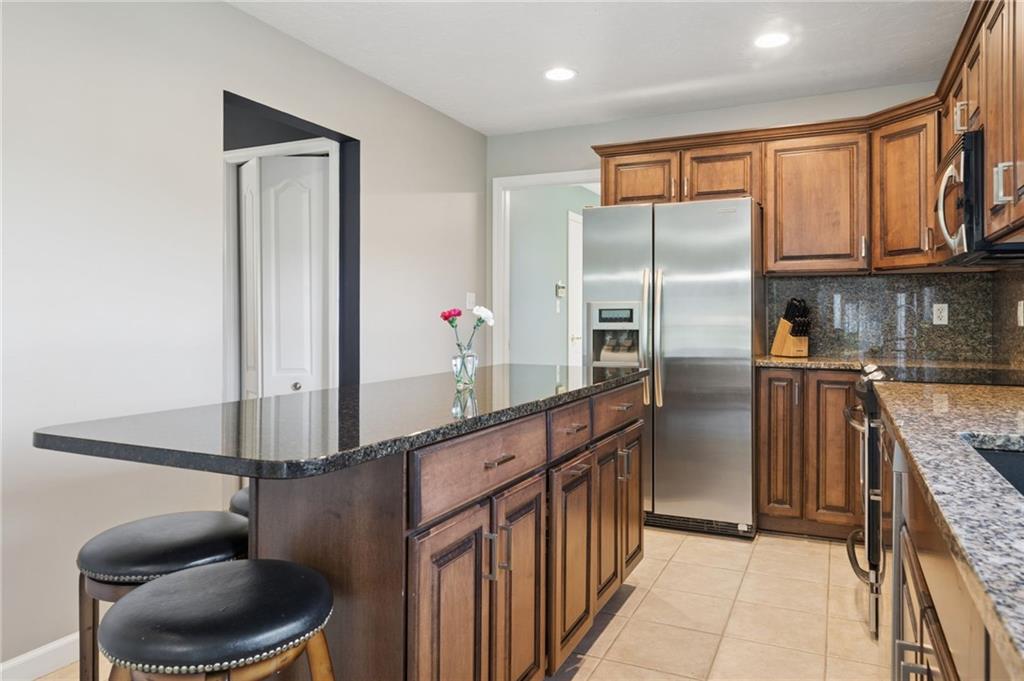 481 Sawmill Road Greensburg, PA 15601 - Photo 11 of 39 a kitchen with stainless steel appliances granite countertop a refrigerator and a stove top oven