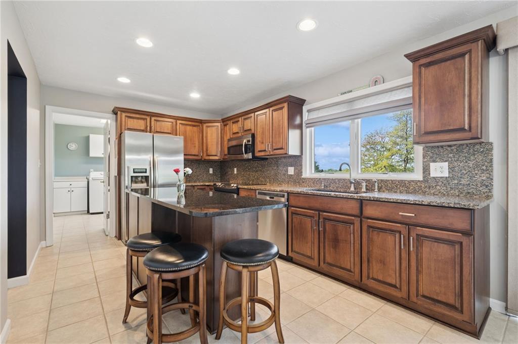 481 Sawmill Road Greensburg, PA 15601 - Photo 12 of 39 a kitchen with granite countertop wooden cabinets and stainless steel appliances