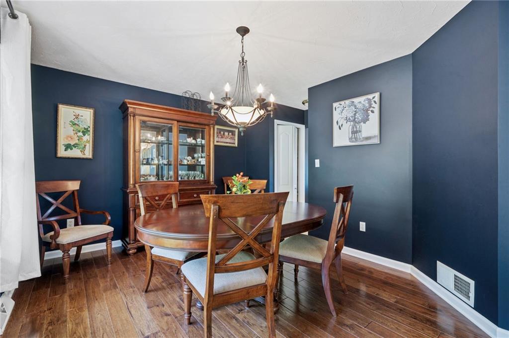 481 Sawmill Road Greensburg, PA 15601 - Photo 14 of 39 a dining room with furniture a chandelier and wooden floor