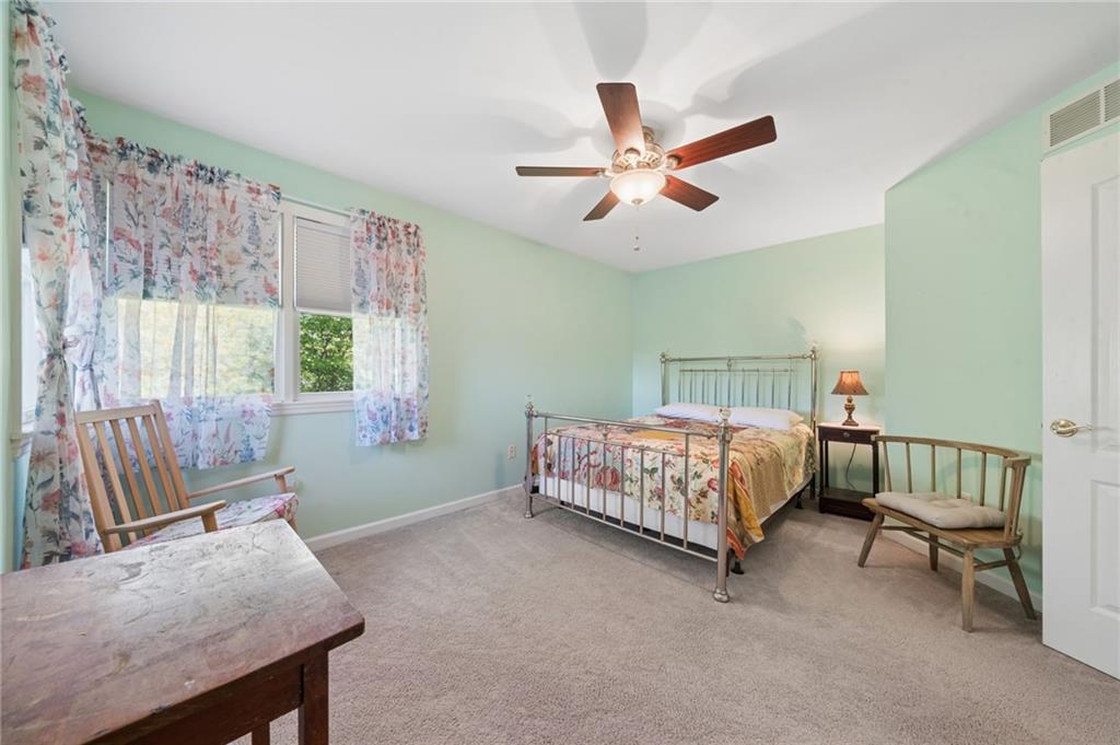481 Sawmill Road Greensburg, PA 15601 - Photo 23 of 39 a bedroom with a bed and a chandelier