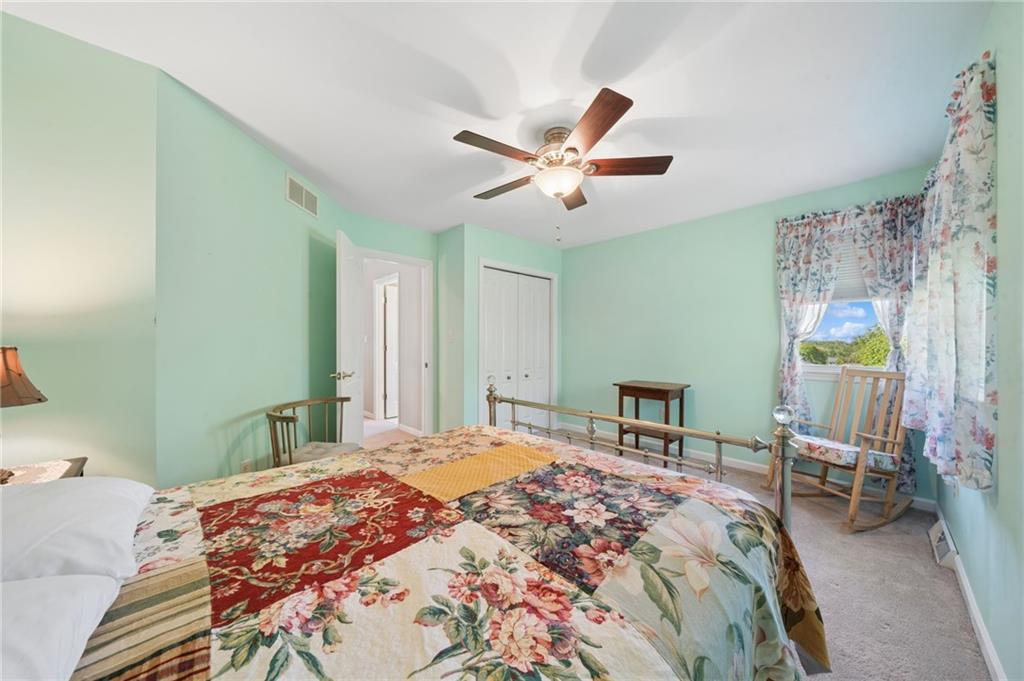 481 Sawmill Road Greensburg, PA 15601 - Photo 24 of 39 a bedroom with a bed and a chandelier