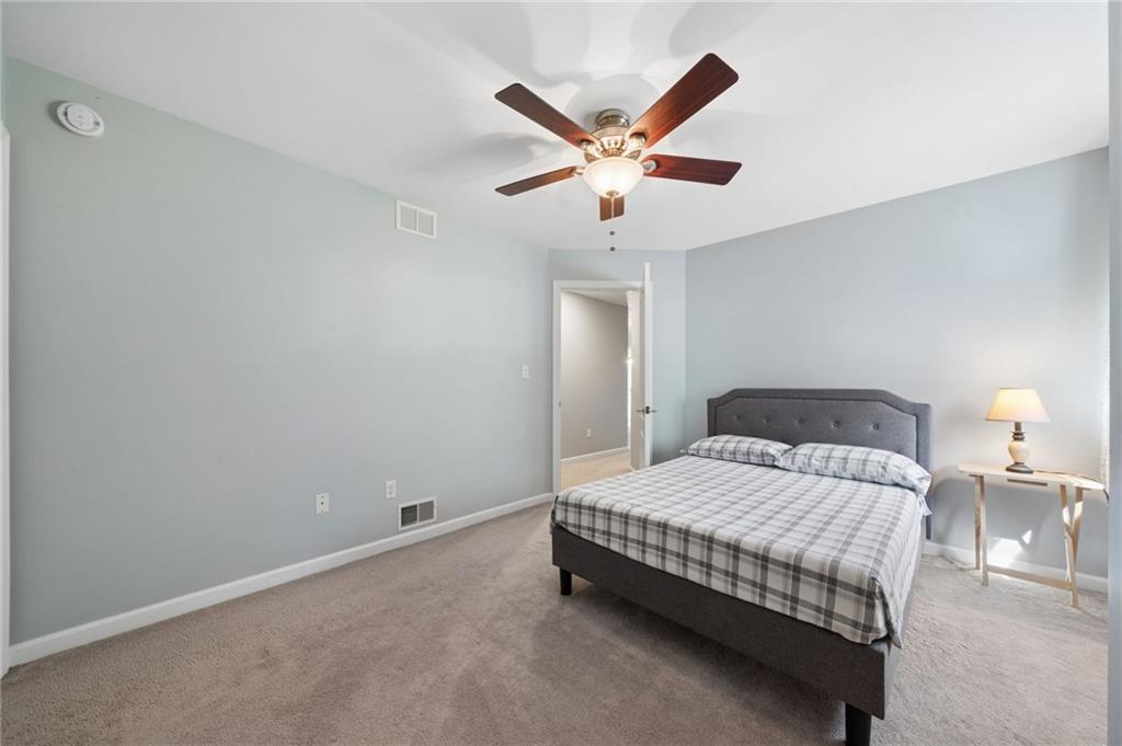 481 Sawmill Road Greensburg, PA 15601 - Photo 27 of 39 a bedroom with a bed and a chandelier