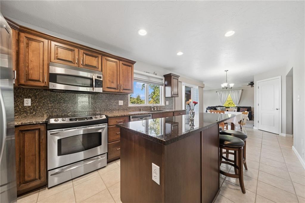 481 Sawmill Road Greensburg, PA 15601 - Photo 10 of 39 a kitchen with stainless steel appliances granite countertop a stove a sink and a microwave