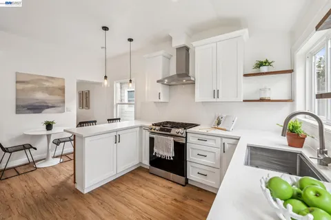 a view of a kitchen with electric appliances and windows