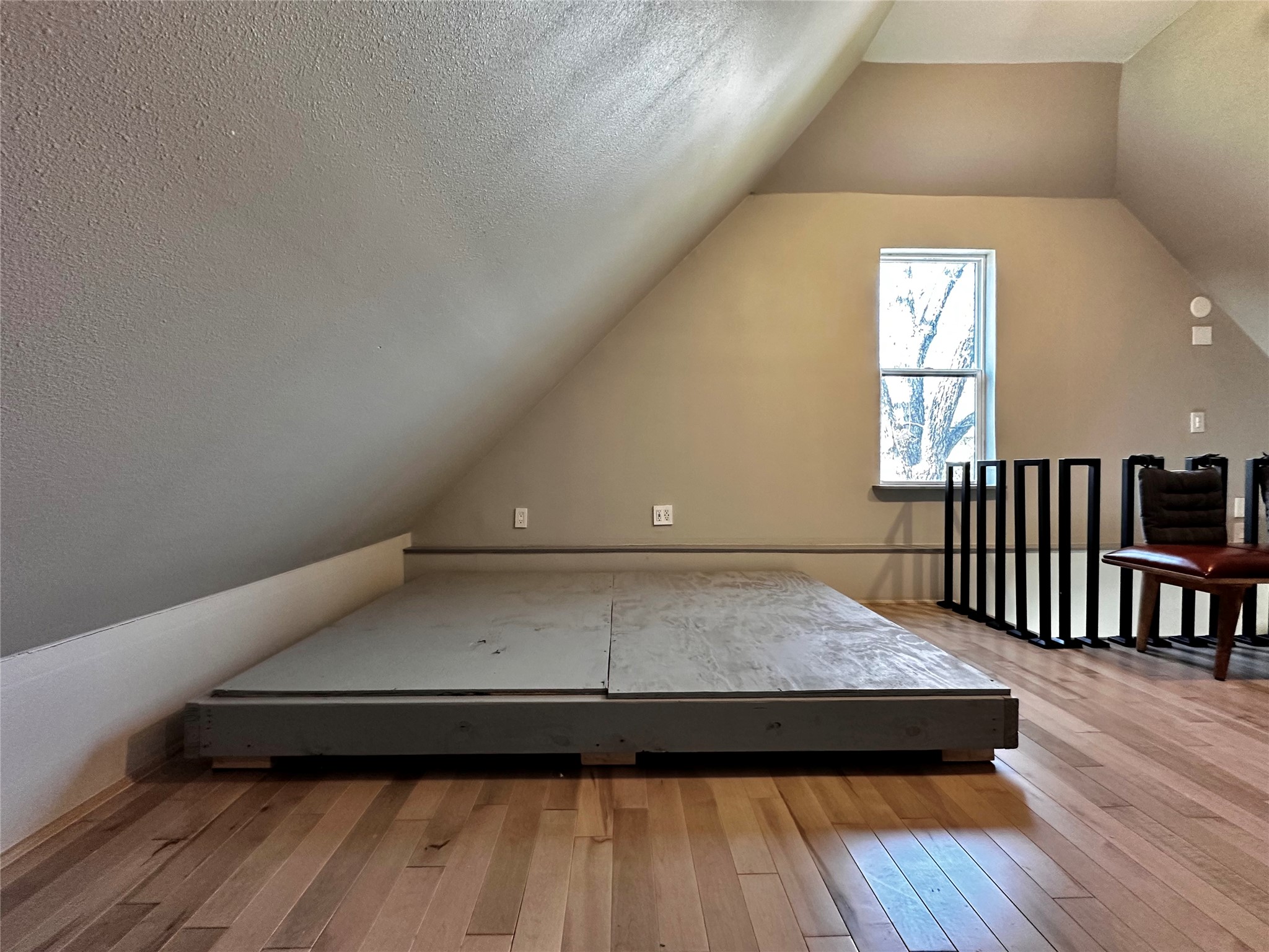 914 East 39th Street, Unit 2 Austin, TX 78751 - Photo 22 of 34 Bedroom loft room with vaulted ceiling and light wood-type flooring