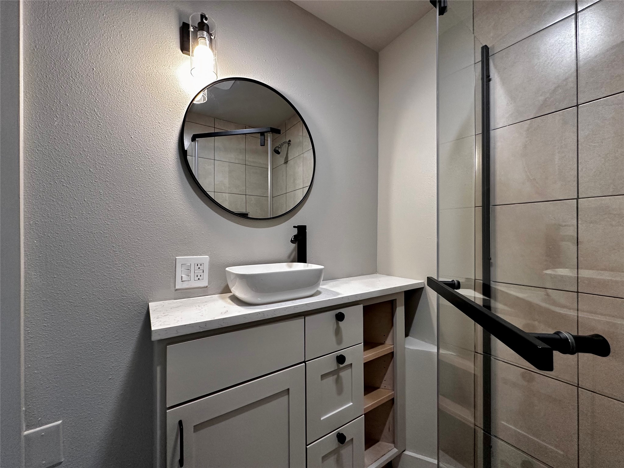 914 East 39th Street, Unit 2 Austin, TX 78751 - Photo 26 of 34 Full bath featuring a shower stall, vanity, and a textured wall