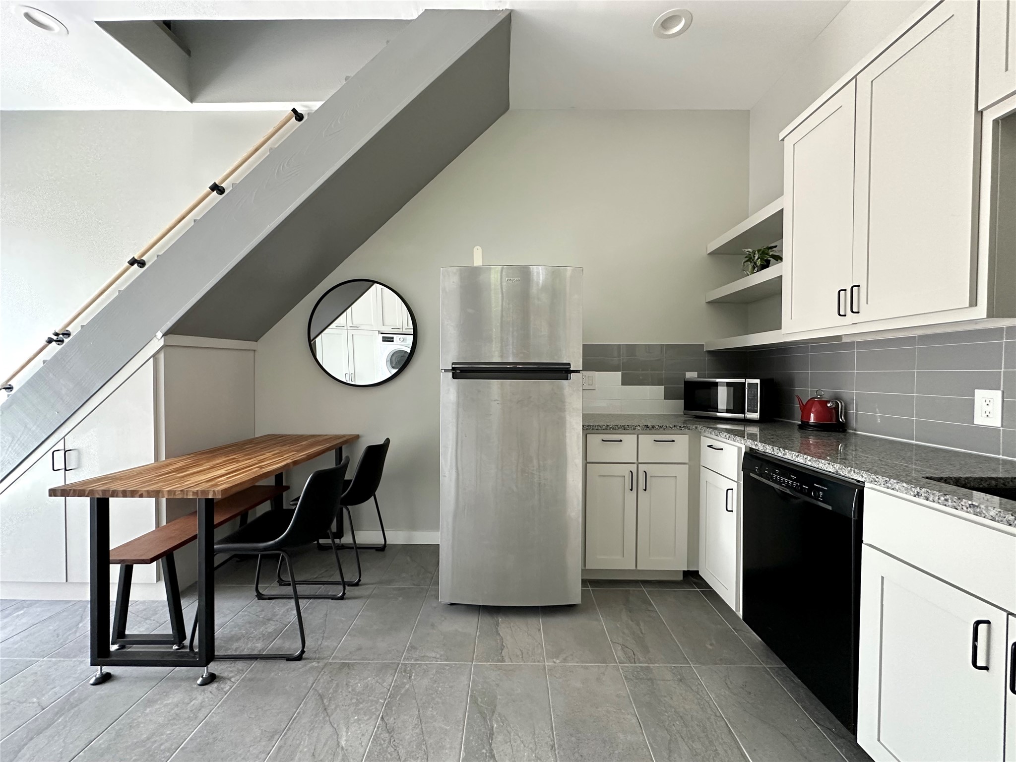 914 East 39th Street, Unit 2 Austin, TX 78751 - Photo 7 of 34 Kitchen featuring open shelves, stainless steel appliances, light stone countertops, white cabinetry, and tasteful backsplash