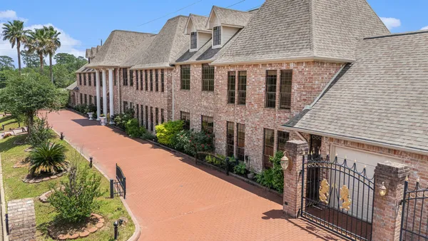 a view of a house with wooden fence
