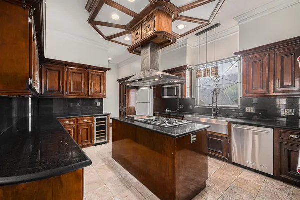 a living room with a black white checkered floor with a gaming machine and dining chairs