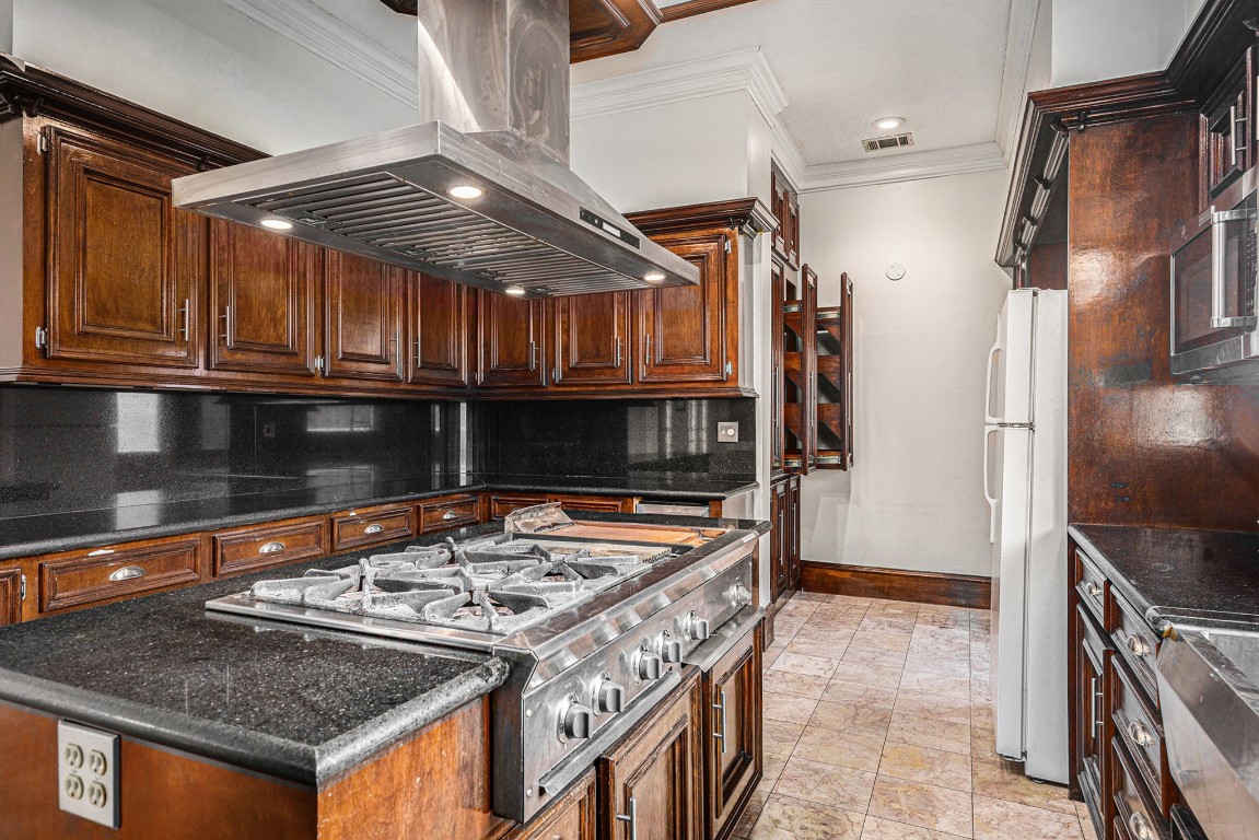 7415 Naremore Drive Spring, TX 77379 - Photo 16 of 47 a kitchen with stainless steel appliances granite countertop a stove and a refrigerator
