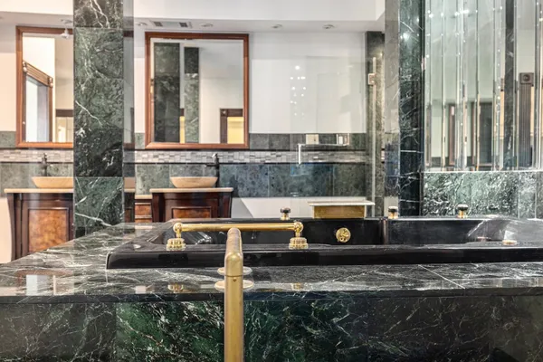 a bathroom with a toilet sink and mirror