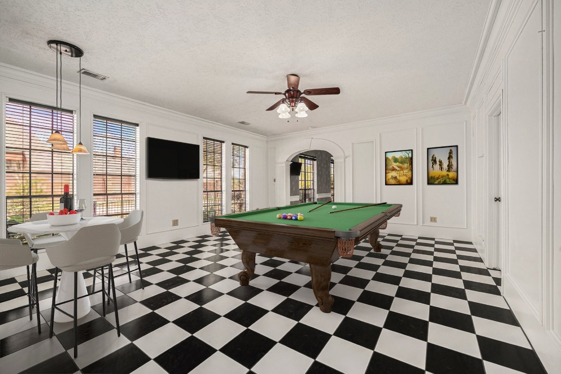 7415 Naremore Drive Spring, TX 77379 - Photo 31 of 47 a living room with a black white checkered floor with a gaming machine and dining chairs