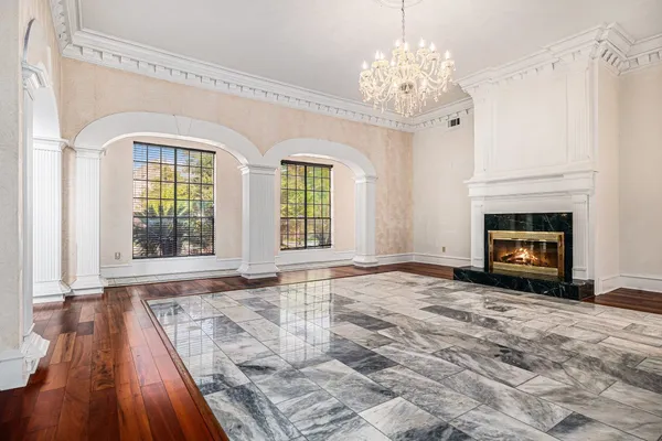 a spacious bedroom with a bed and a flat screen tv